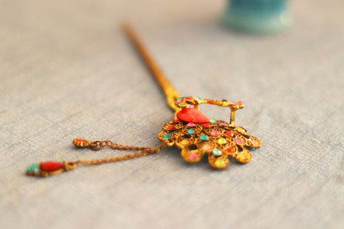 Free Elegant handmade peacock hair stick adorned with colorful beads and gold design. Stock Photo