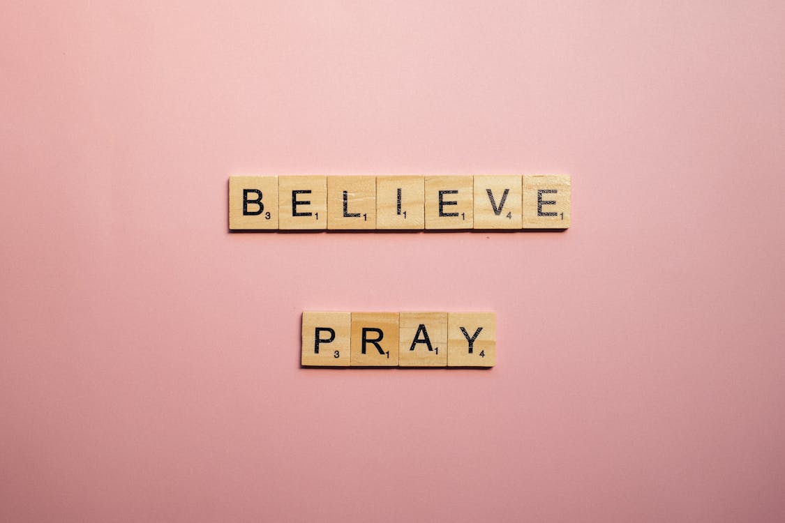 Free A Believe and Pray Words of Encouragement  on Pink Surface Stock Photo