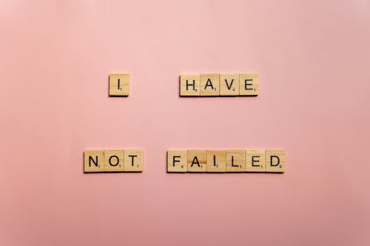 Scrabble tiles spelling 'I have not failed' on a pink background, offering an inspirational message.