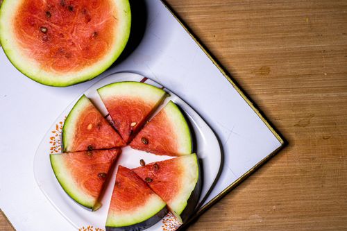 Free Top view of juicy watermelon slices on a white plate, perfect for summer refreshment. Stock Photo