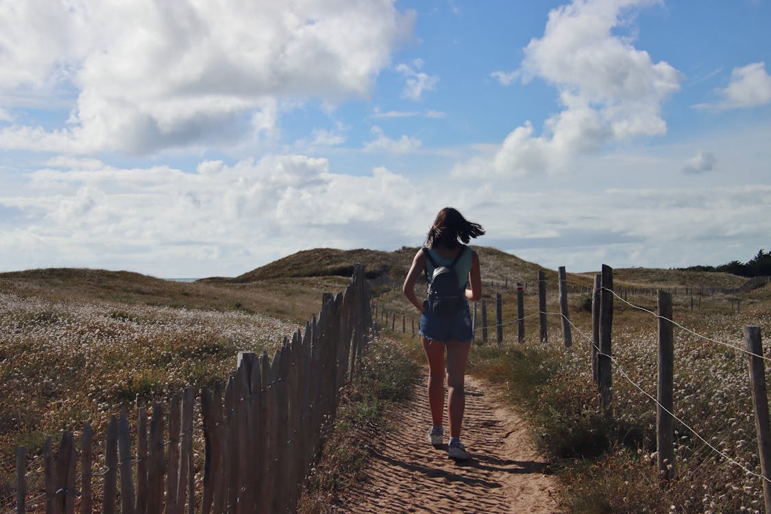 Woman Walking on the Pathway