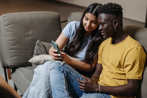 Couple Sitting with Smartphone