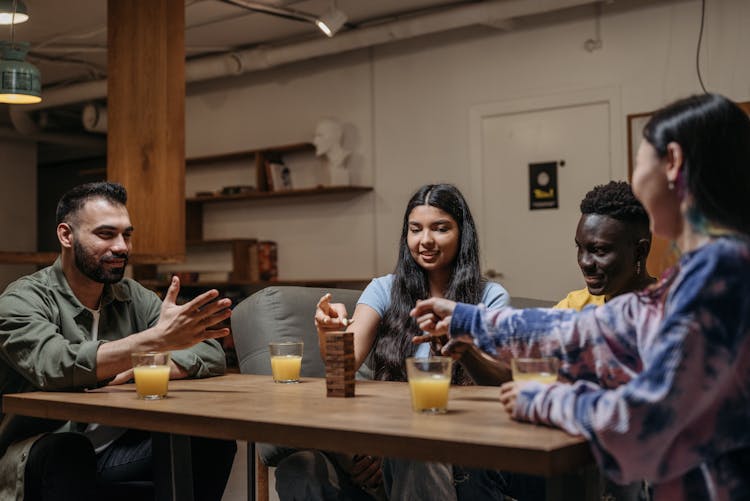 Group Of People Playing A Jenga Game
