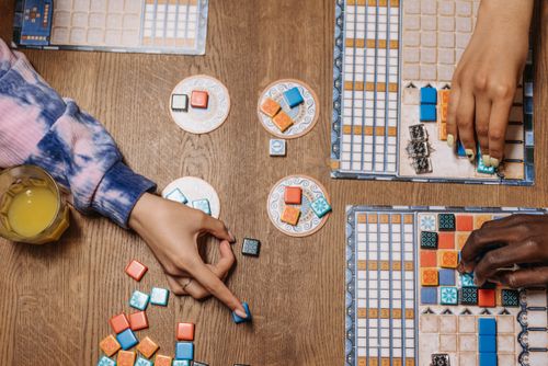 Hands playing a board game