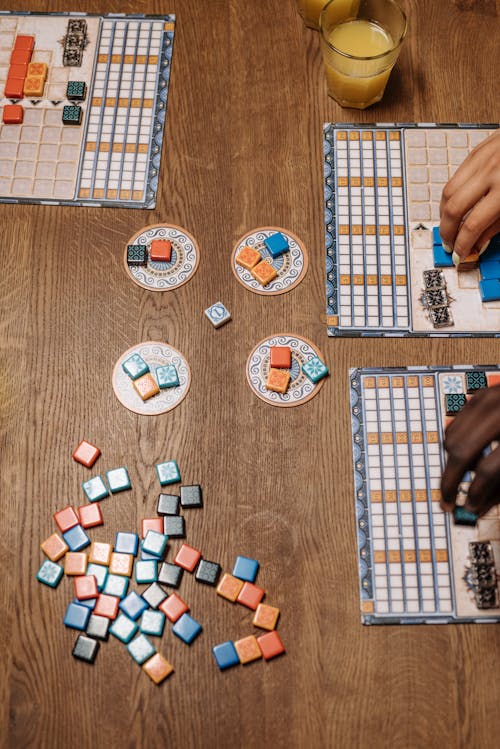 People Playing Board Game with Dice