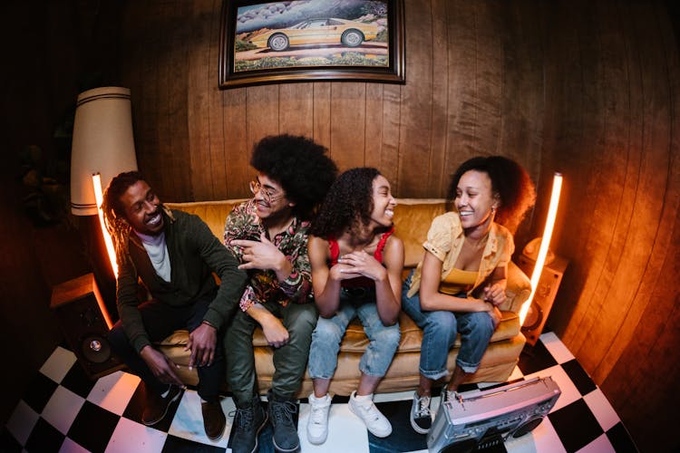 Group Of People Sitting On Couch