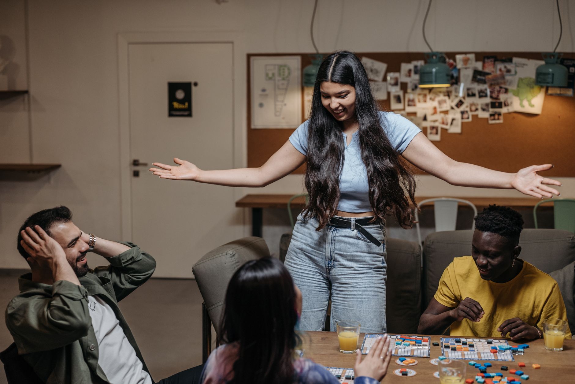 Group of diverse friends playing board games indoors, having fun together.
