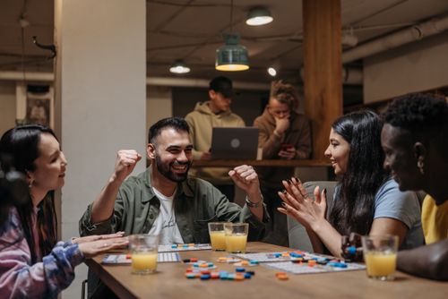 Friends smiling while playing a board game