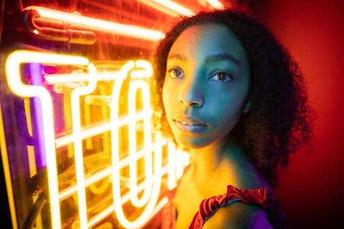 Young Woman Standing Beside Neon Lights