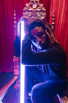 An expressive portrait of a man sitting on a throne with dynamic lighting and rich colors.