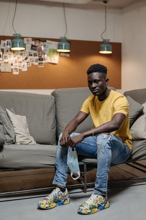 Man in T-shirt Sitting with Mask on Couch