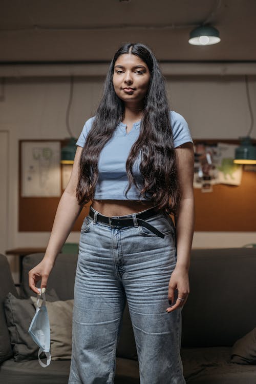 Woman in Blue Crop Top and Denim Jeans 