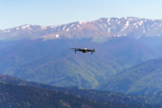Aerial shot of a drone flying above scenic Carpathian Mountains in Romania.