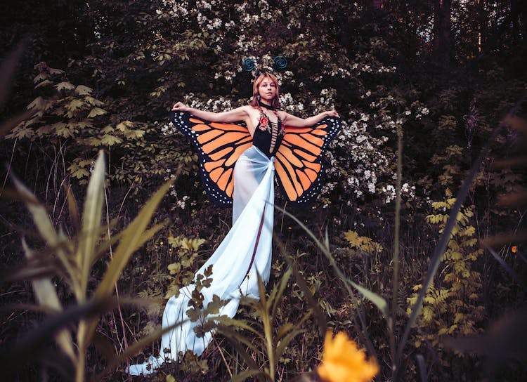 Woman In Butterfly Costume In Wild Nature