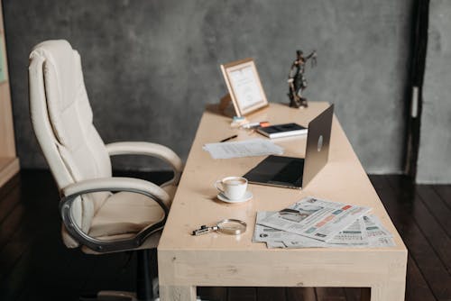 Free 
A Desk with a Laptop and a Cup of Coffee Stock Photo