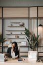 Woman in Black Blazer Standing Near Green Plant