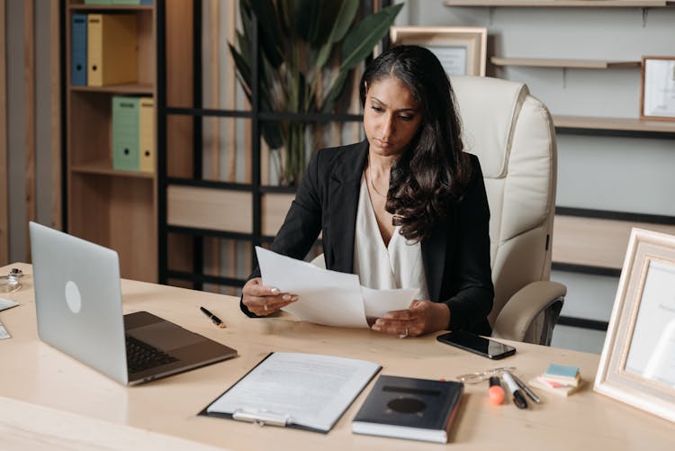 Woman Working At The Desk In Office