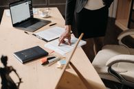 Person in Black Blazer Holding Brown Wooden Chopsticks