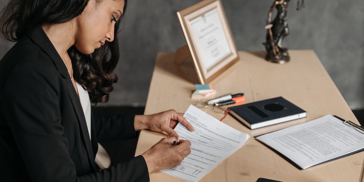 A lawyer reviewing legal documents at a desk