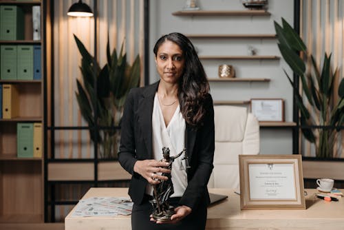 Female Lawyer holding a Lady Justice Statuette 