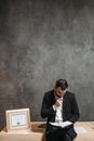 Man in Black Suit Jacket Sitting on Chair