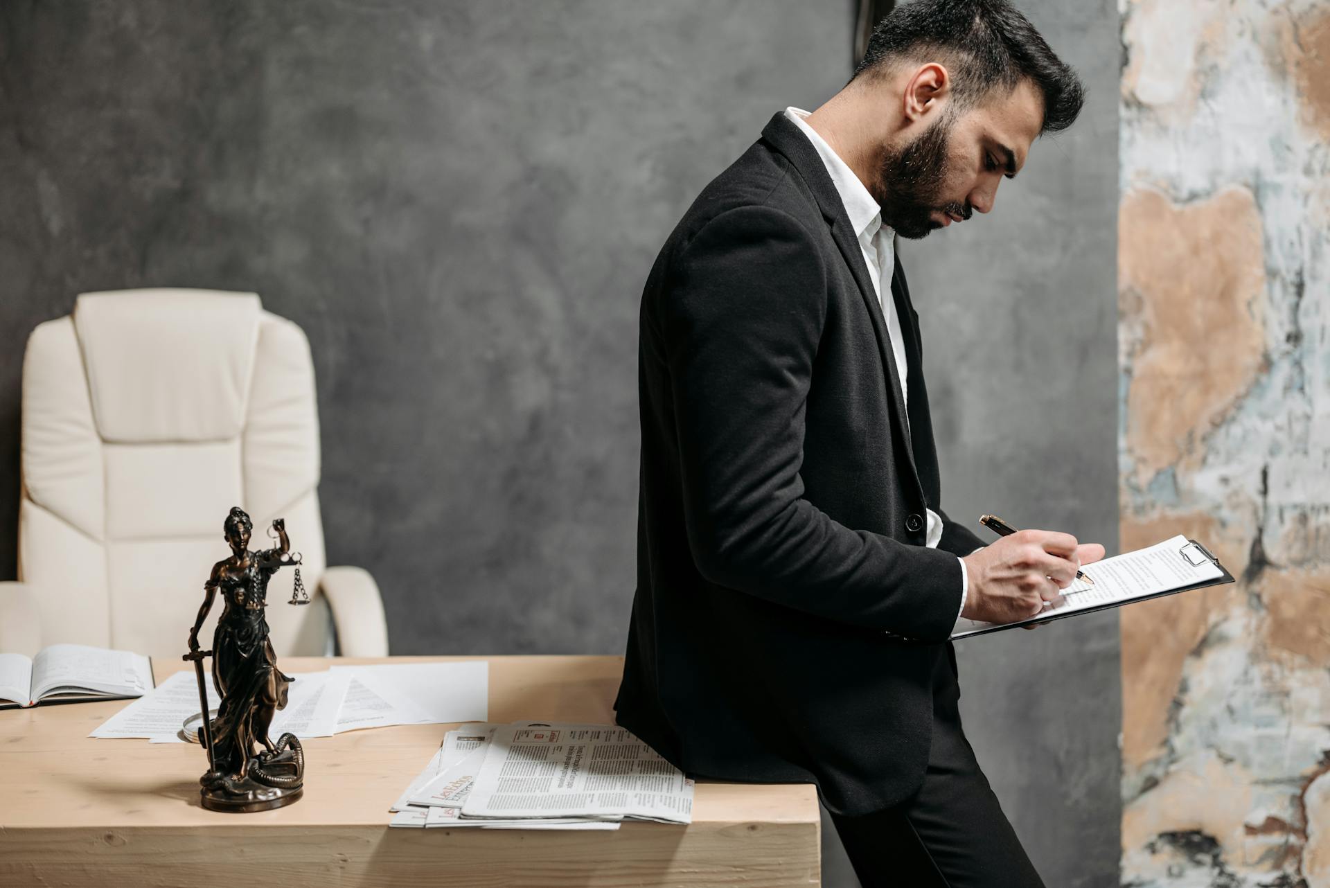 A Man in Black Suit Reading a Contract