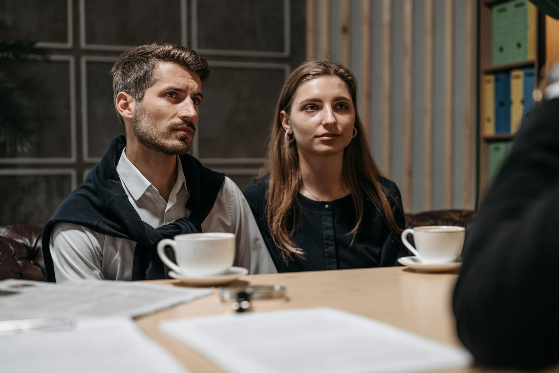 Business meeting with a couple engaging with a consultant in a modern office setting.