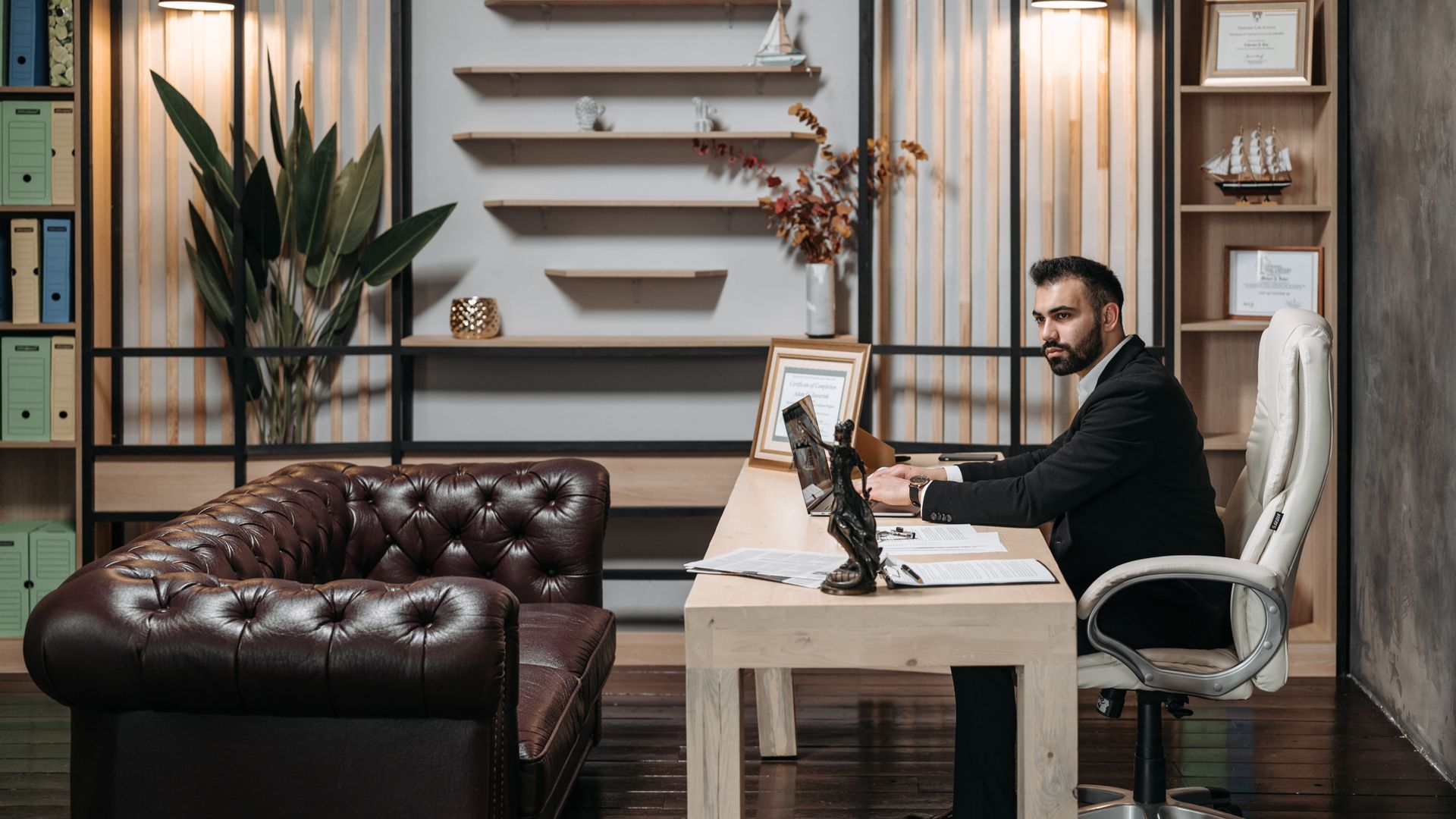 Modafinil for Remote Workers: Boost Productivity and Focus Man in a suit working at a desk in a well-designed modern office — modafinil for remote workers