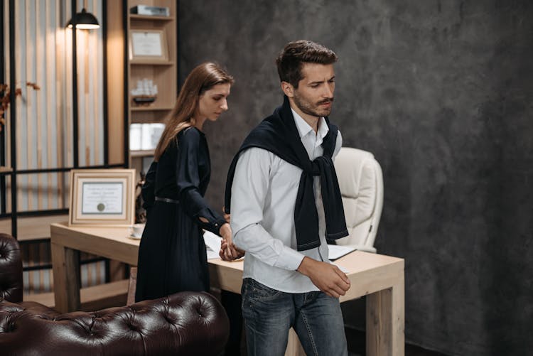 Man In Shirt And Woman Walking At Office