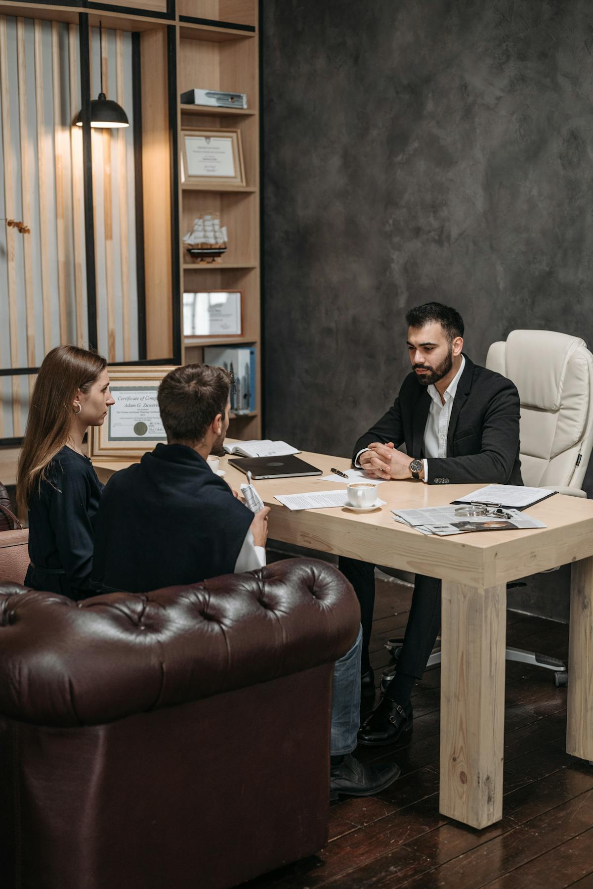 Close-up of a judge gavel on a table next to a pair of headphones