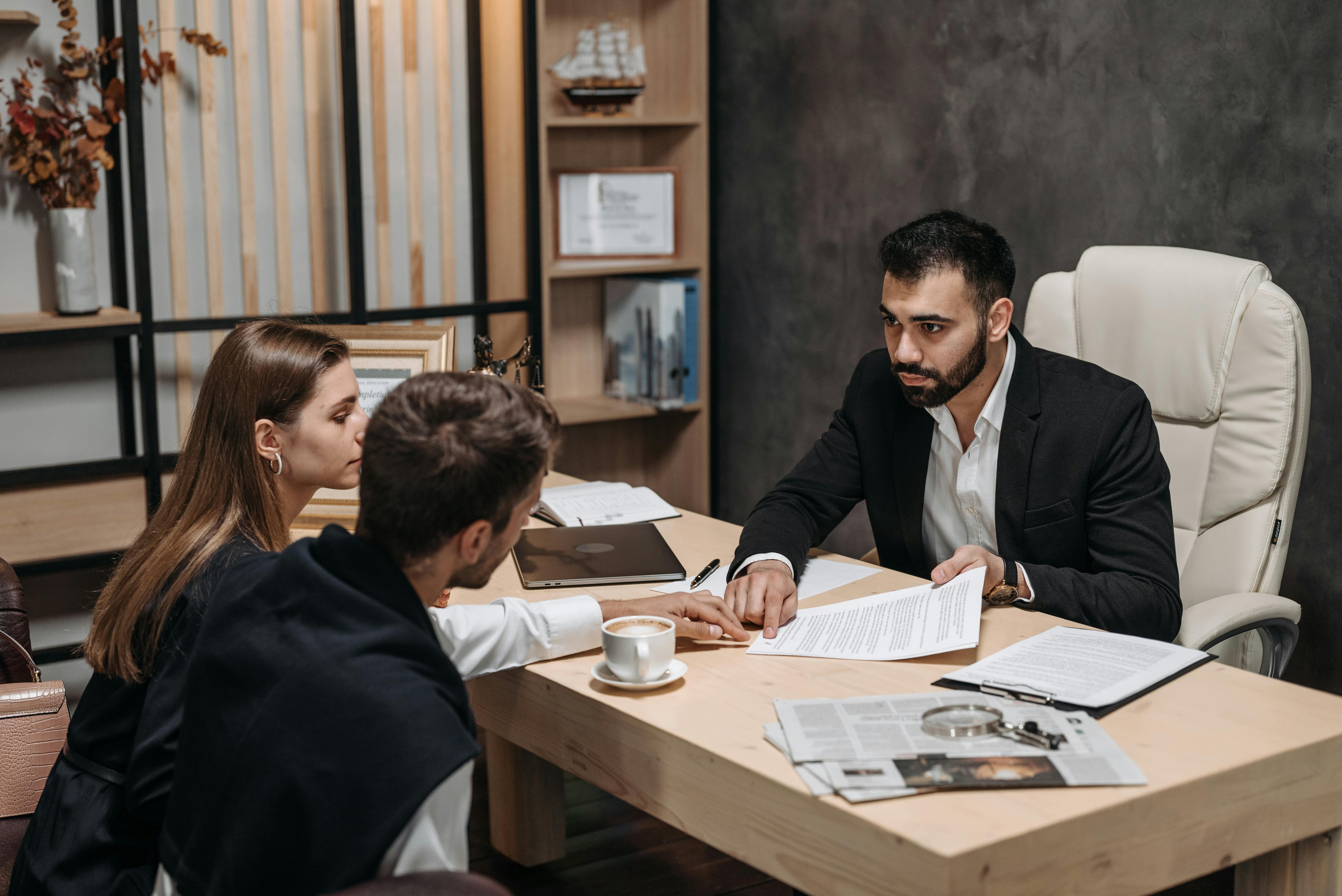 Free A Man in Black Suit Talking to His Clients Stock Photo