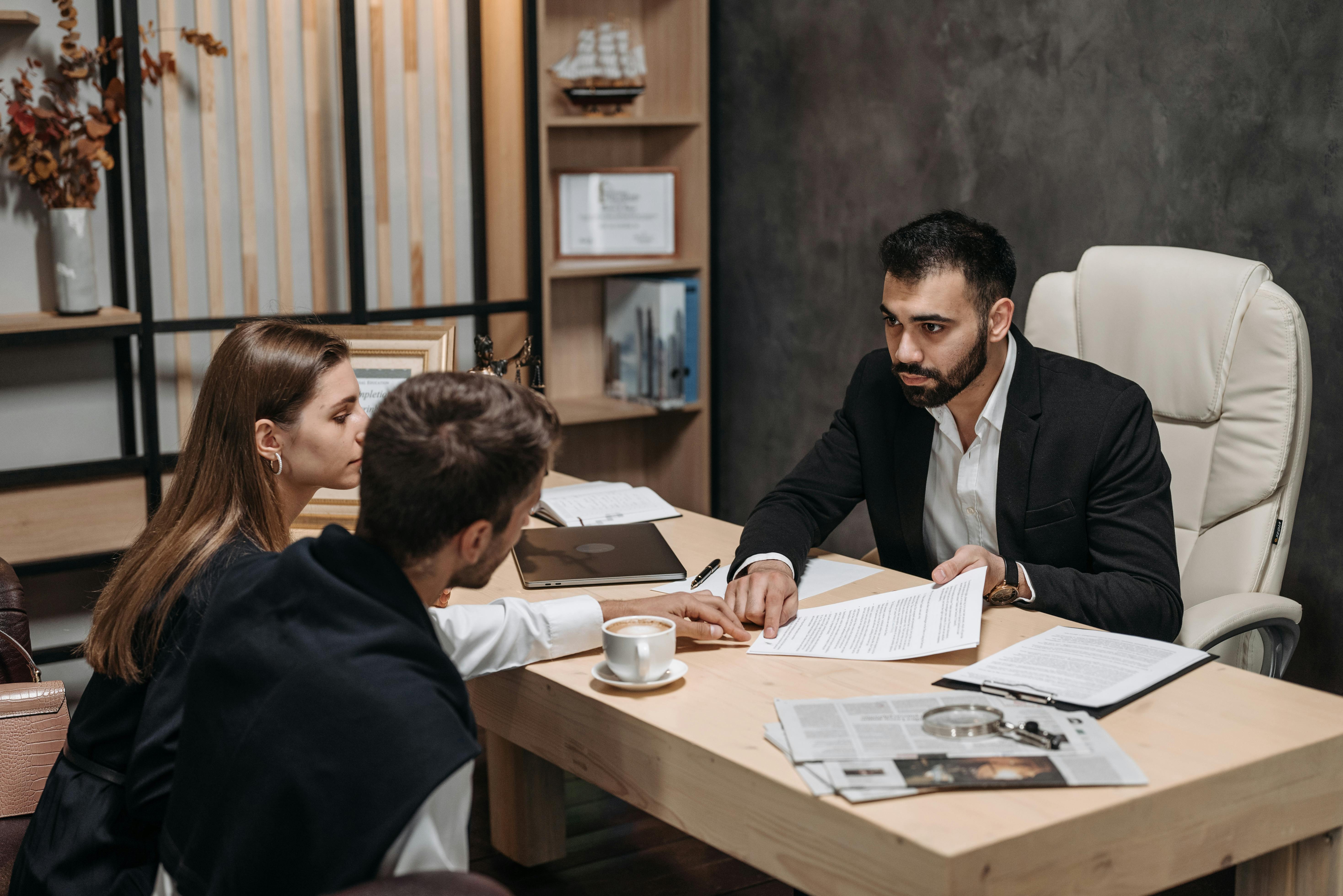 a man in black suit talking to his clients