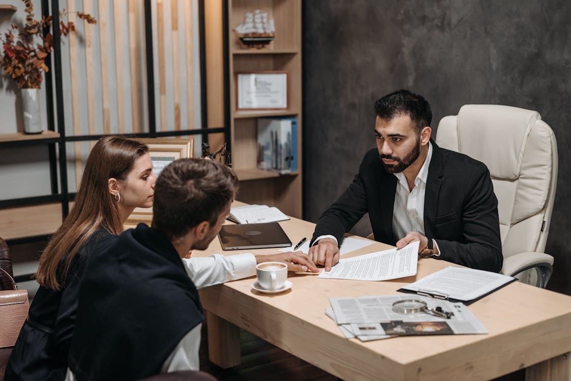 An image of a couple talking to a lawyer