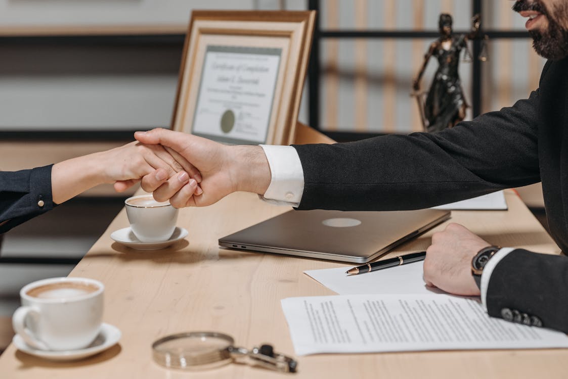 an immigration lawyer shaking a claimant’s hand