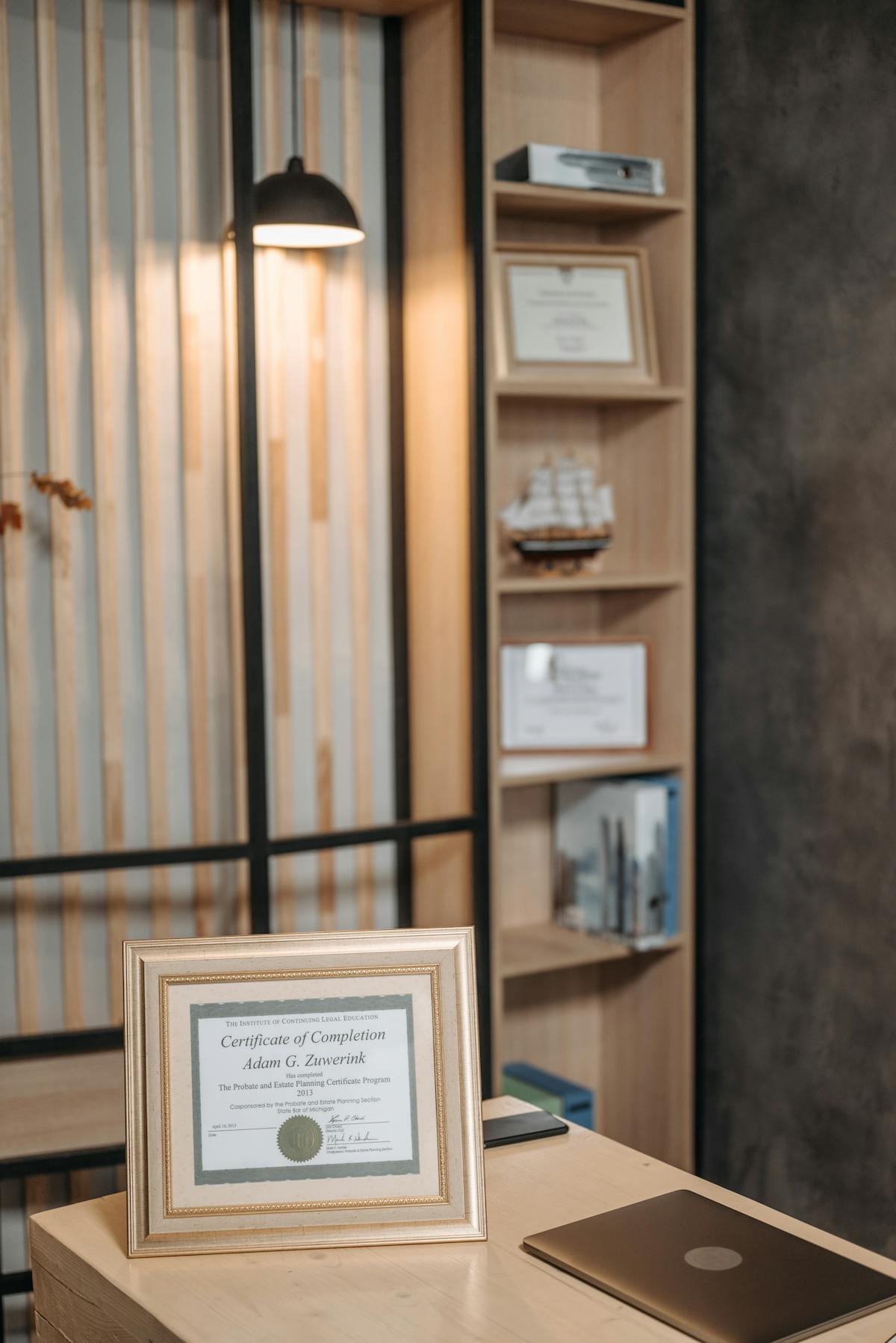 Attorney reviewing legal documents on laptop and smartphone