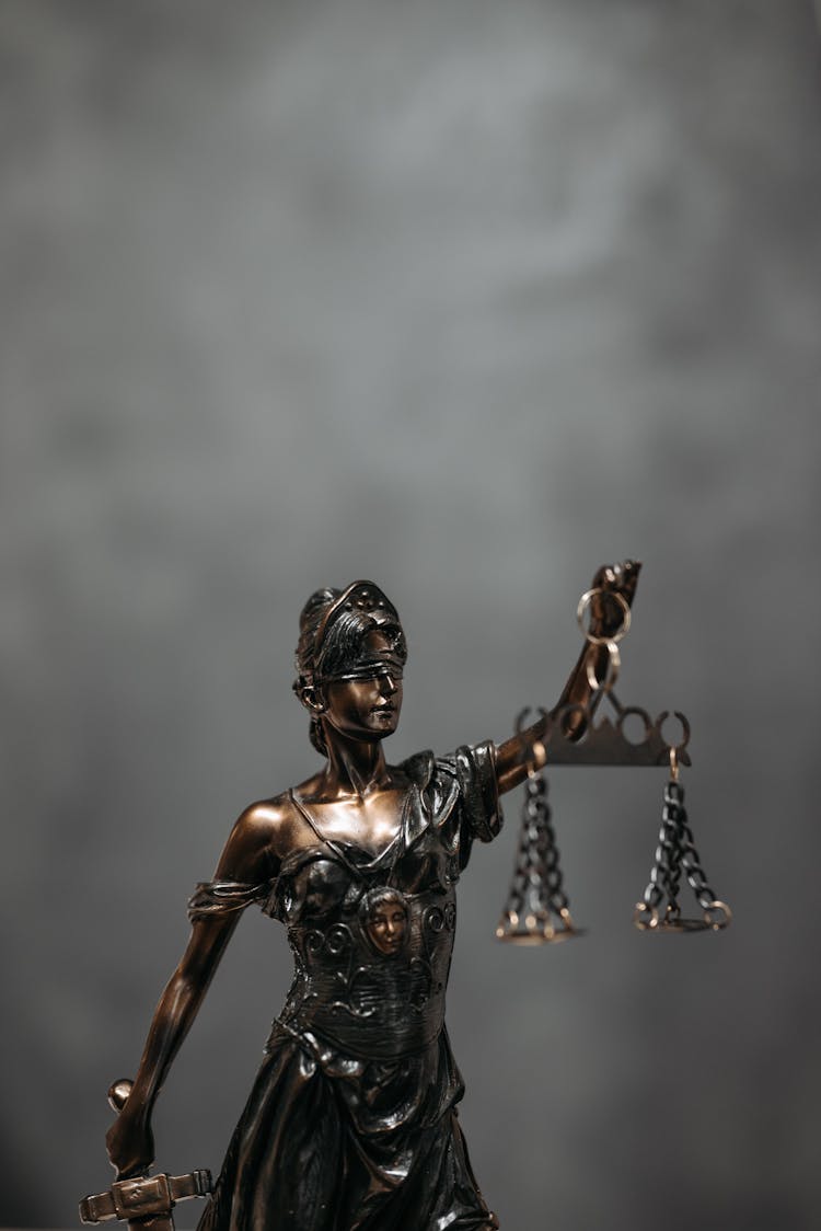 Close-Up Shot Of A Statuette Of Lady Justice 