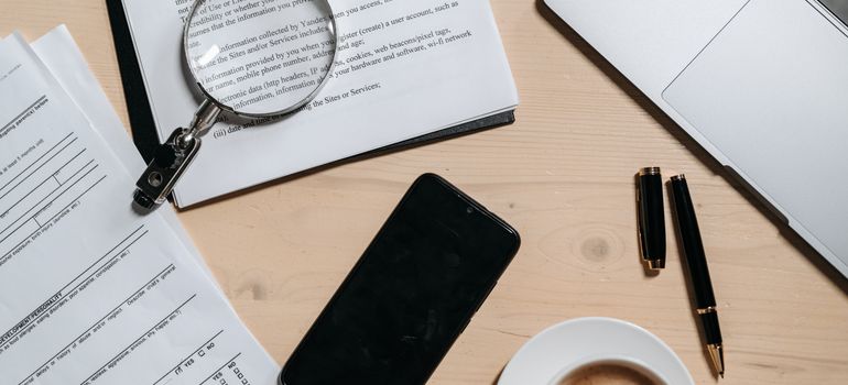 Laptop and documents used to prepare to live on your own for the first time.