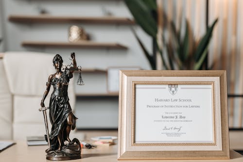 Free Selectvie Focus Photo of a Lady Justice Statuette and Diploma  Stock Photo