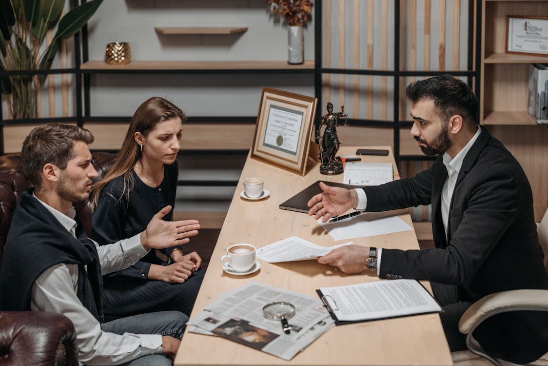 Free Male Lawyer talking to his Clients Stock Photo