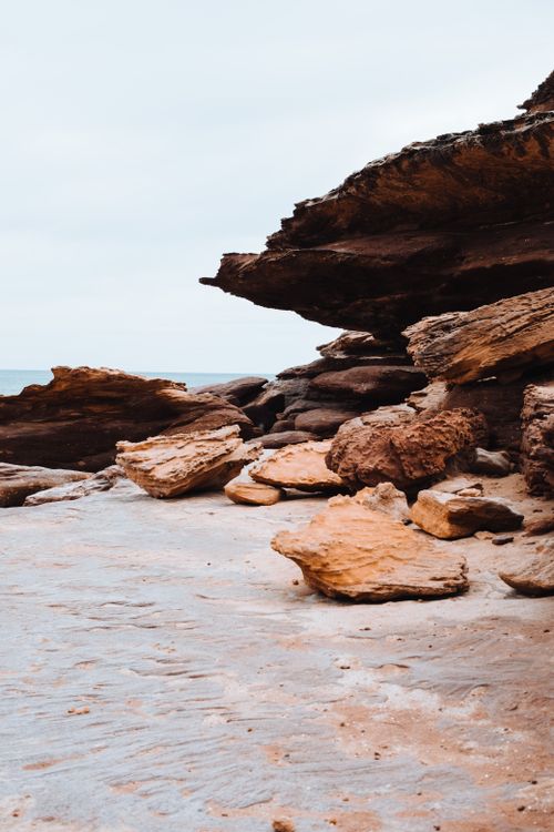 Free Striking geological sandstone rock formations along a coastal shoreline with natural erosion patterns. Stock Photo
