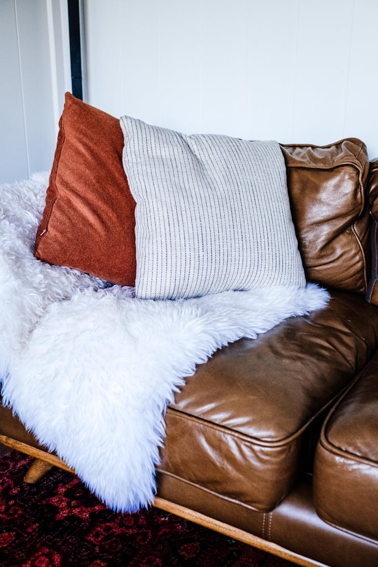 
Pillows And A Fur Blanket On A Leather Couch