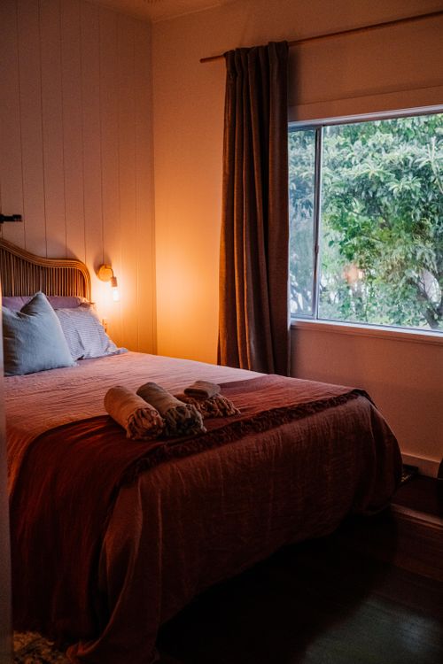 Free Inviting bedroom with warm lighting, elegant decor, and window view. Stock Photo