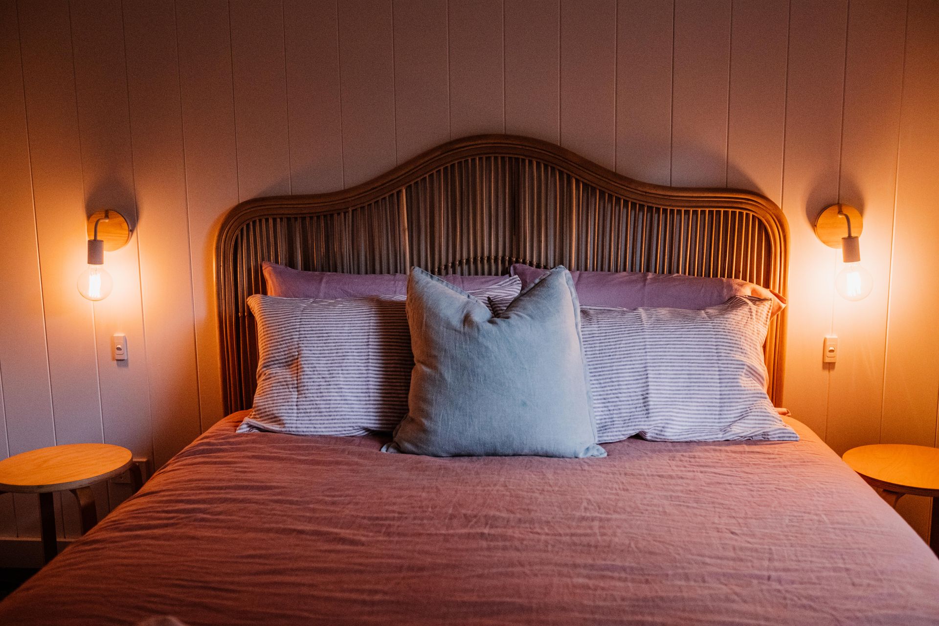 Elegant bedroom scene featuring a stylish bed with soft lighting creating a cozy atmosphere.