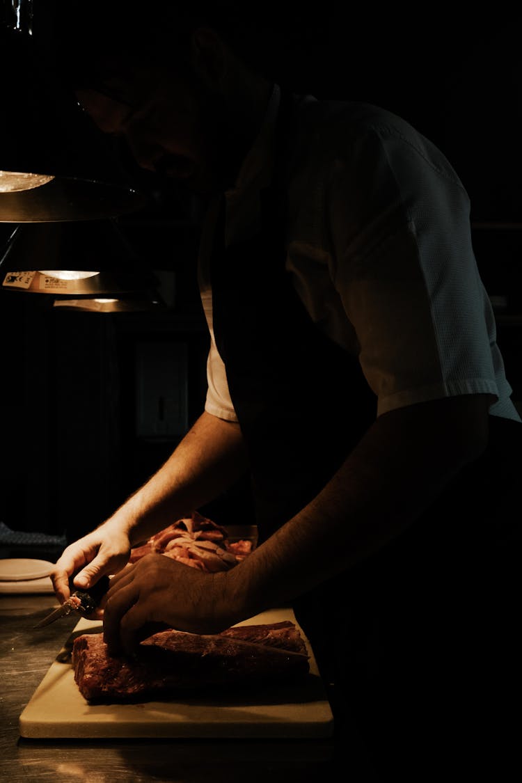 Man In Apron Cooking In Kitchen