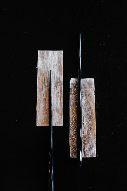 Dried kombu seaweed strips displayed against black background`