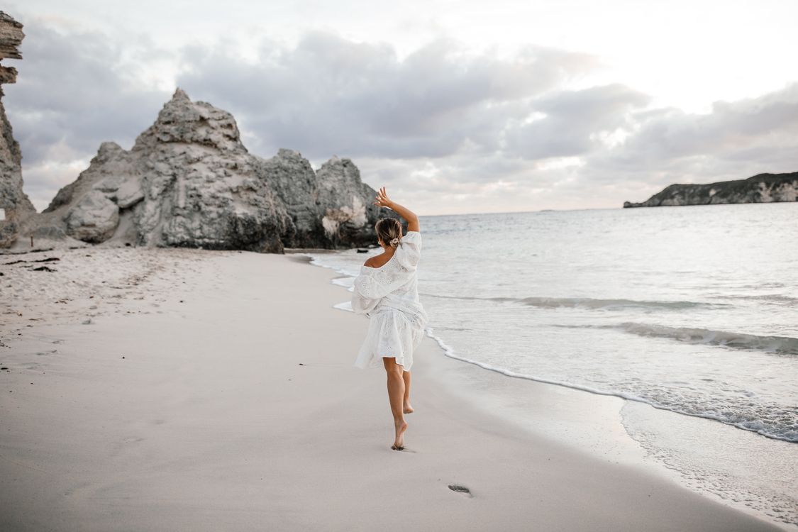Woman in White Dress Standing on Beach · Free Stock Photo