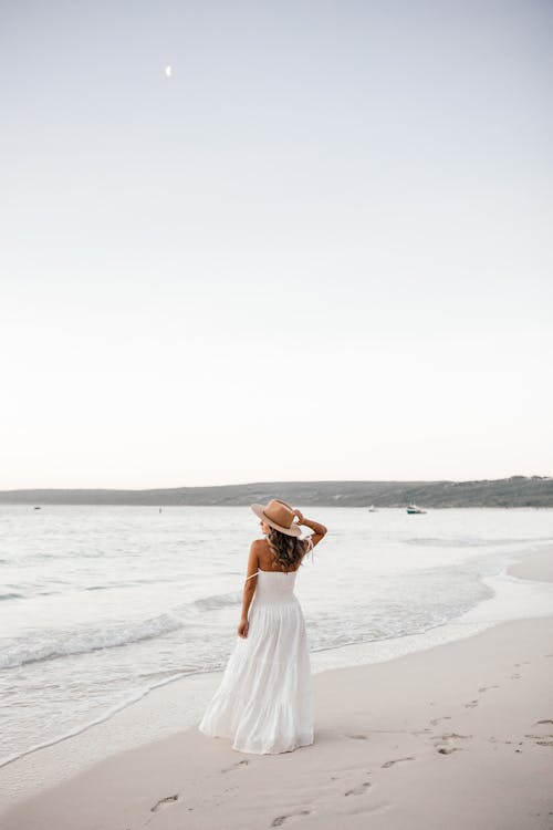 Woman in White Dress Standing on the Beach