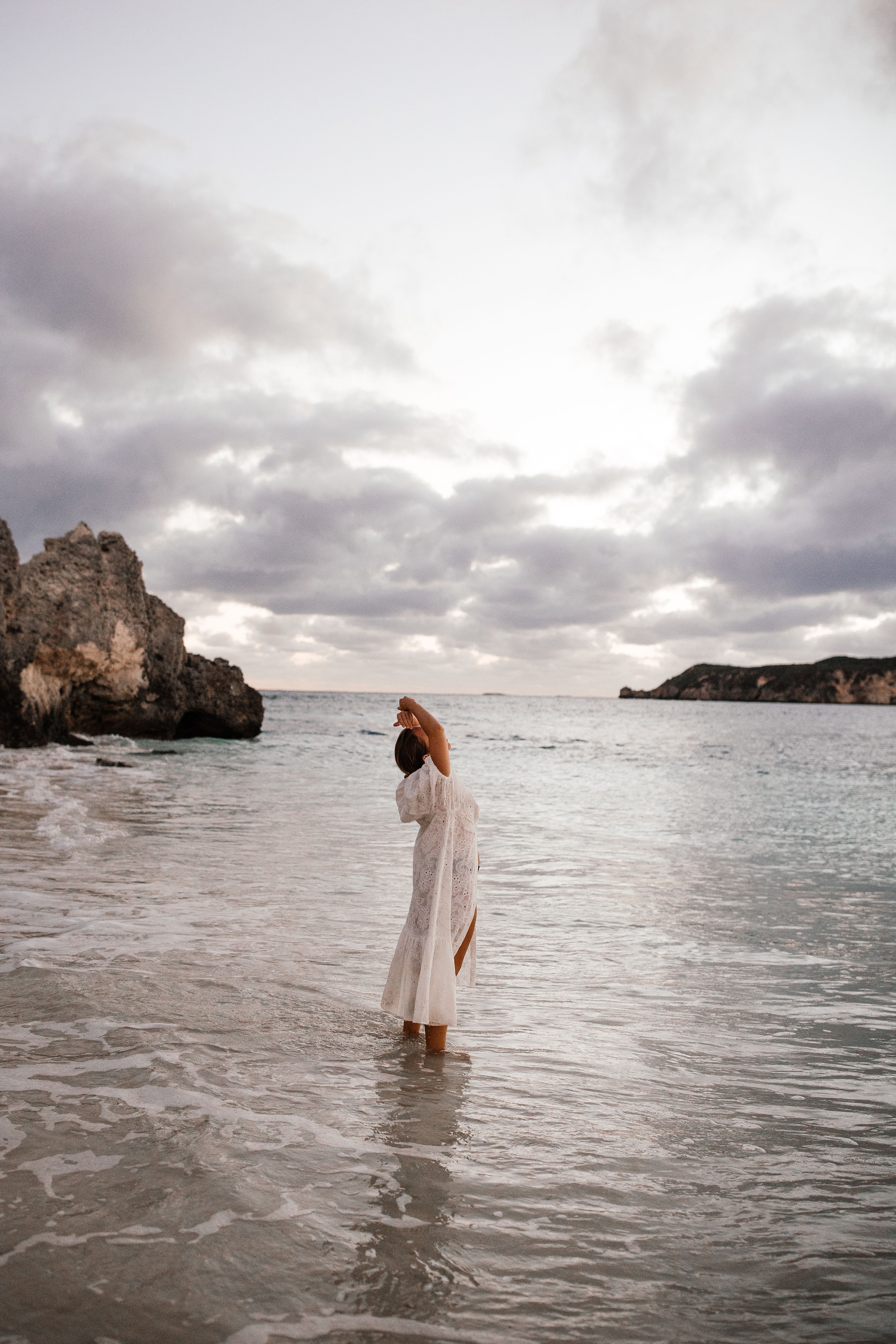 Woman in White Dress Raising Her Arms on Beach · Free Stock Photo