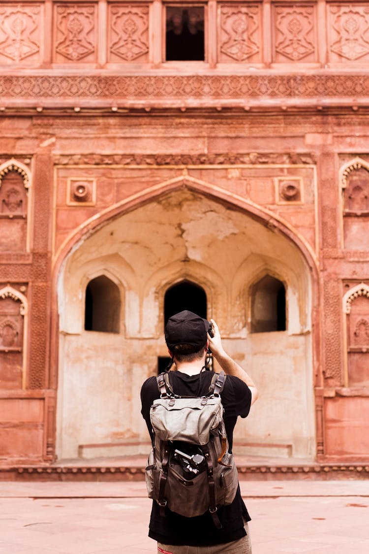 Man Taking Photo Of Traditional Landmark