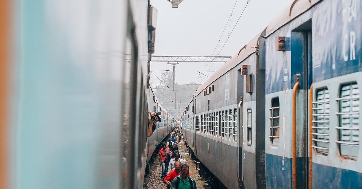 People Using Train People Walking between Trains · Free Stock Photo